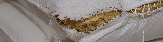 Torn, damp, restitched or poorly closed bags in the stack